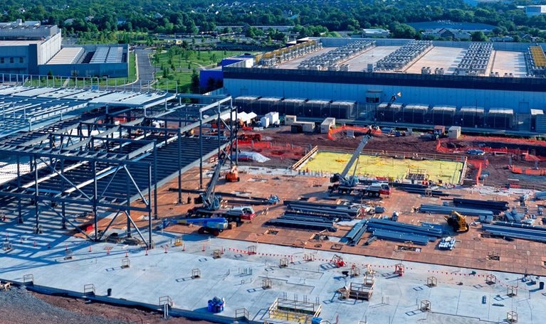 Aerial view of a data center being constructed among existing centers
