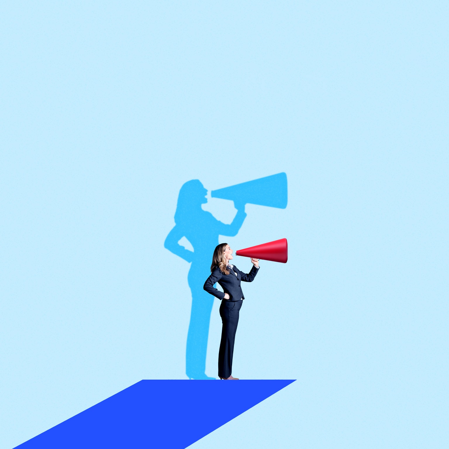 A woman in a business suit stands on a blue platform, speaking energetically into a red megaphone. Behind her, a blue shadow on the light-blue background mimics her pose, also holding a megaphone.