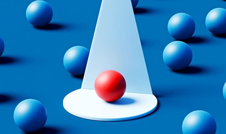 A single red sphere rests on a white circular platform beneath a focused cone of light, standing out vividly among numerous blue spheres scattered across a deep teal background.