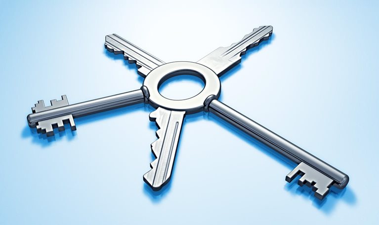 Five metallic keys with different bits joined together on single central ring, arranged like spokes set against a light blue background.