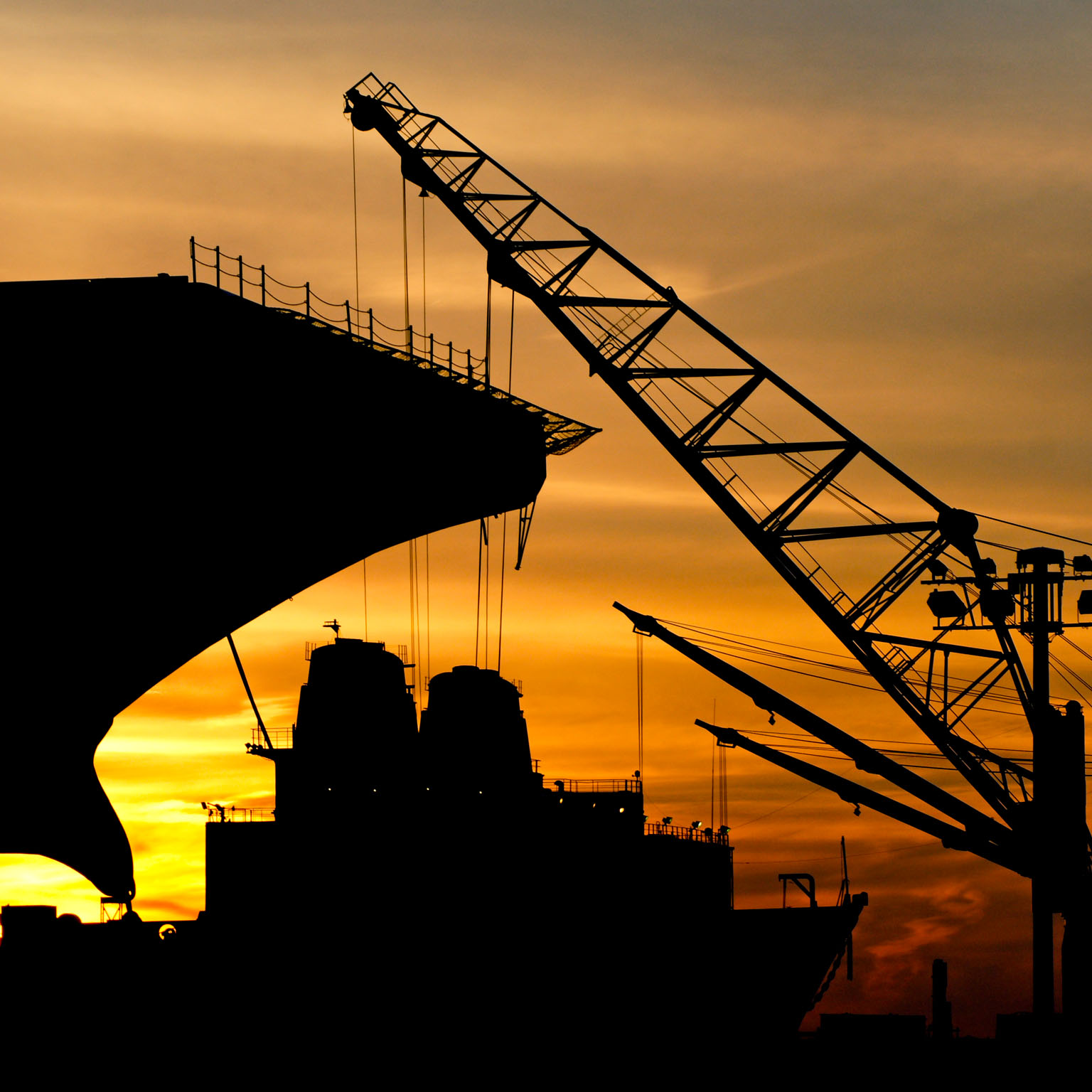 Silhouette of a ship and crane during sunset at the Philadelphia Navy Yard.