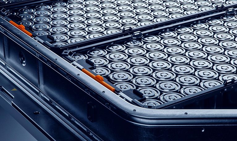 Close-up of High capacity EV Battery Pack with Orange Connectors Isolated on a Black Background.