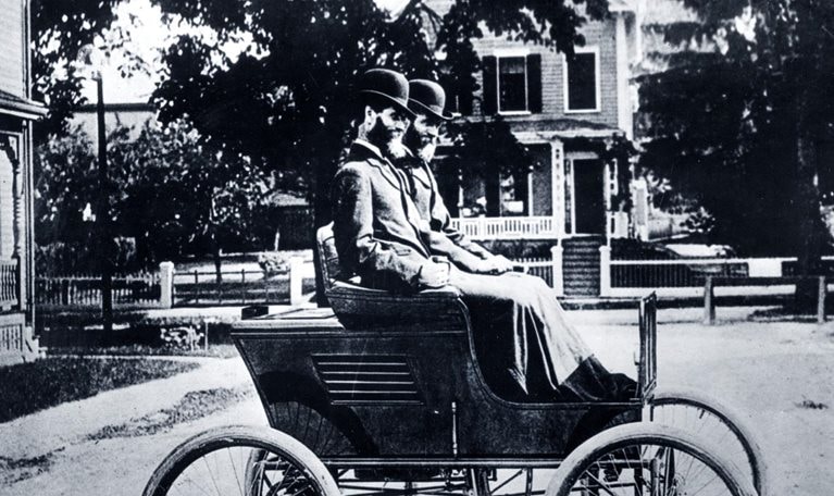 Portrait of twins and automobile manufacturers Freelan (1849-1940) and Francis Stanley (1849-1918) as they pose in their Stanley Steamer car, 1897.