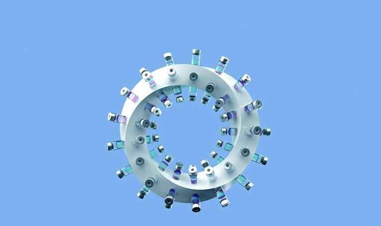 A twisting ring with vaccine vials affixed to its perimeter.