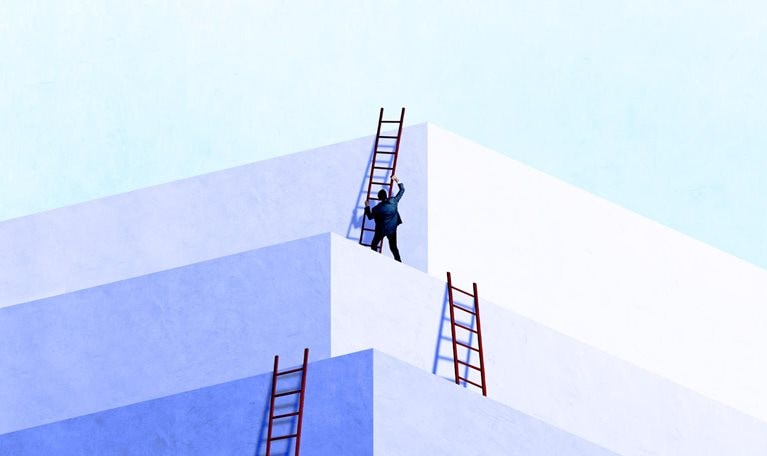 A person in business attire climbing a red ladder positioned against a series of large, white geometric blocks arranged like stepped platforms.
