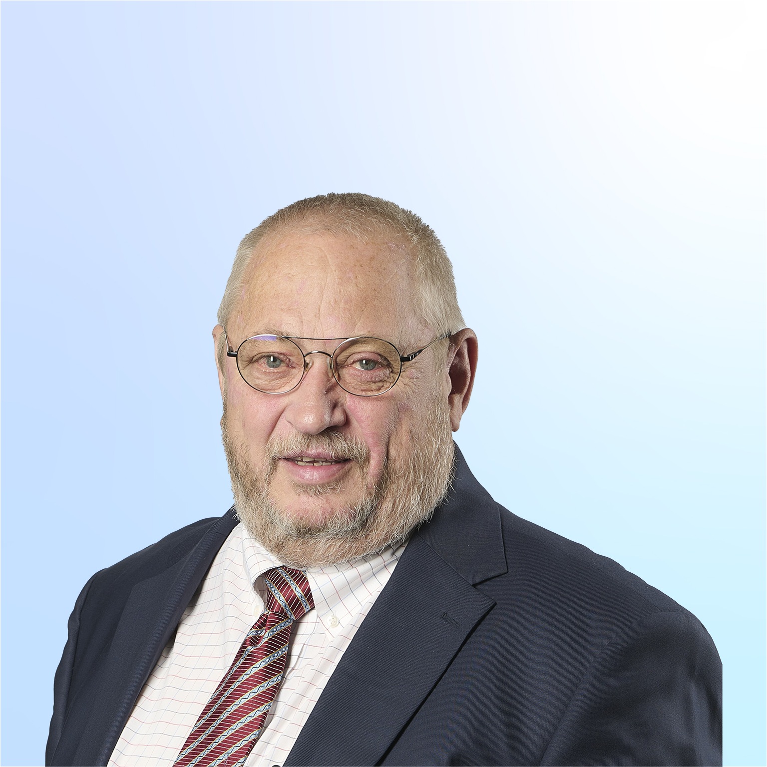 Neal Froneman in a suit against a light blue background