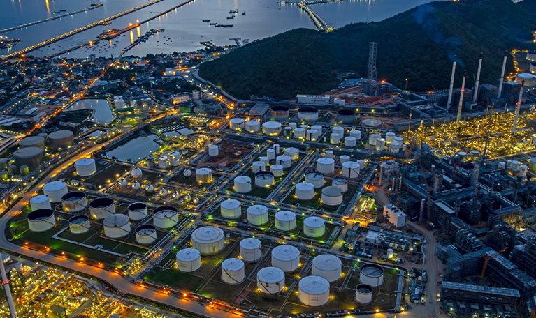 Aerial view oil refinery and fuel storage tanks at night time.
