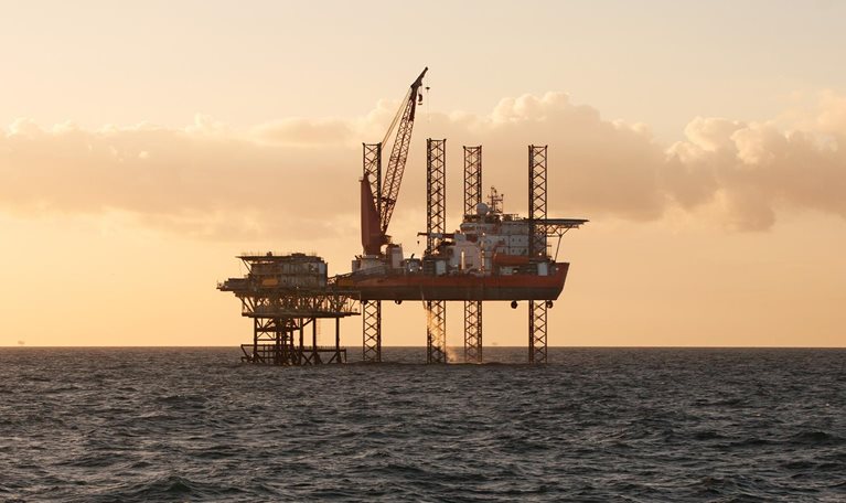 Jack Up heavy lift ship at sunset - stock photo