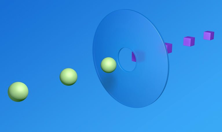 A 3D render of 3 spheres and 4 cubes meeting in the middle. A clear disc with a hole in the middle bridges the two sides.
