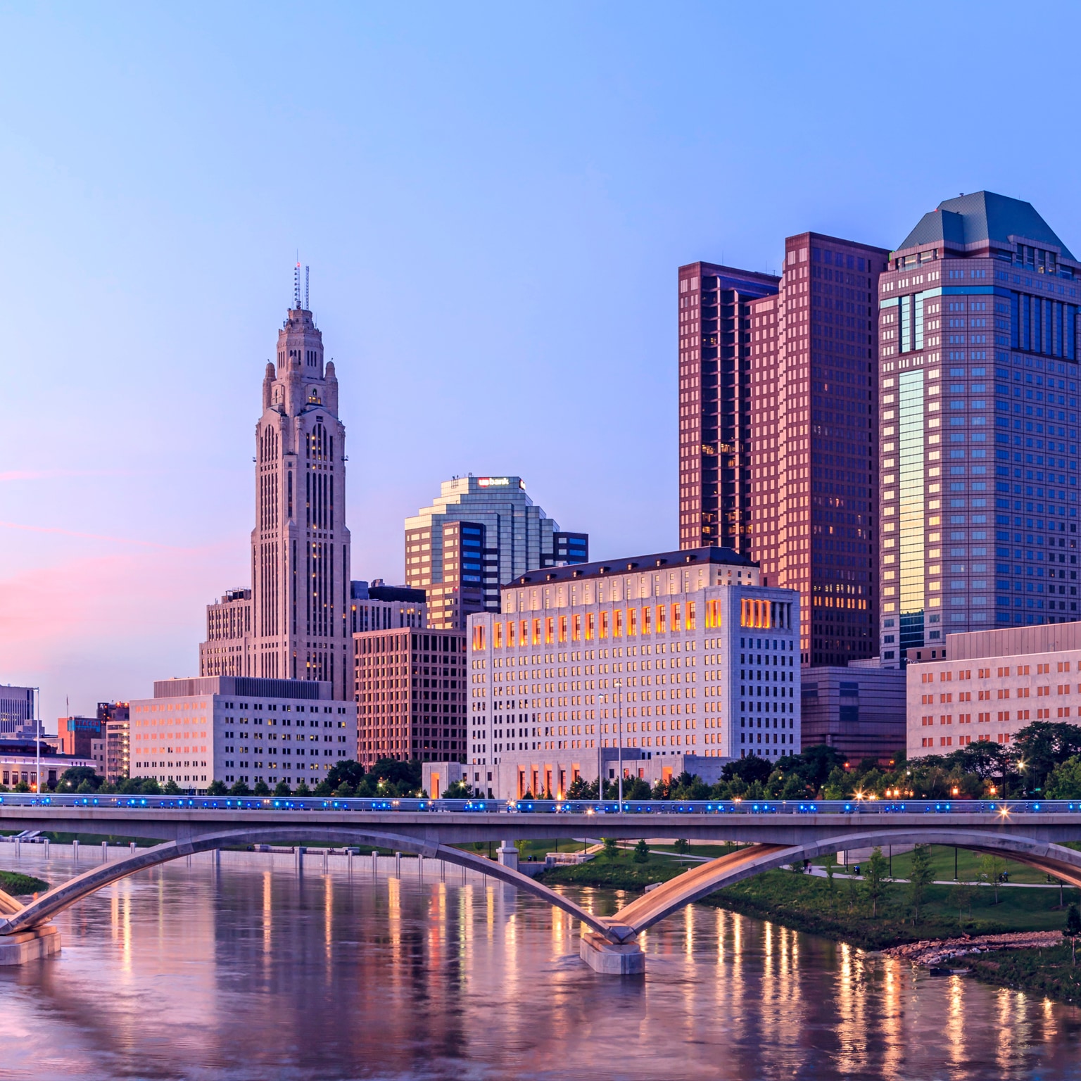 A skyline view of Colombus against a bridge