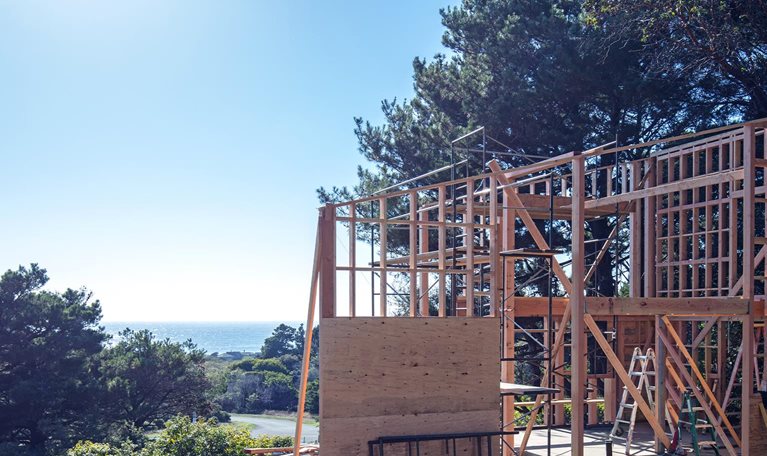 House construction framing in California by Pacific Ocean.