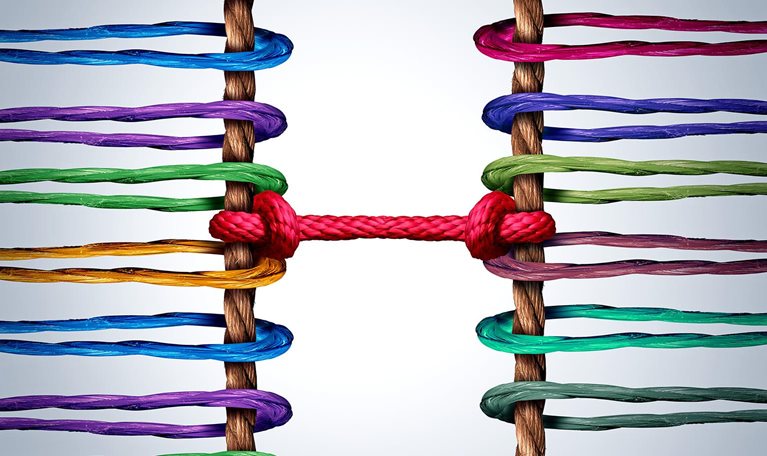 Image of two groups of ropes linked and tied together by a central rope as symbolizing connection and mediation between groups.