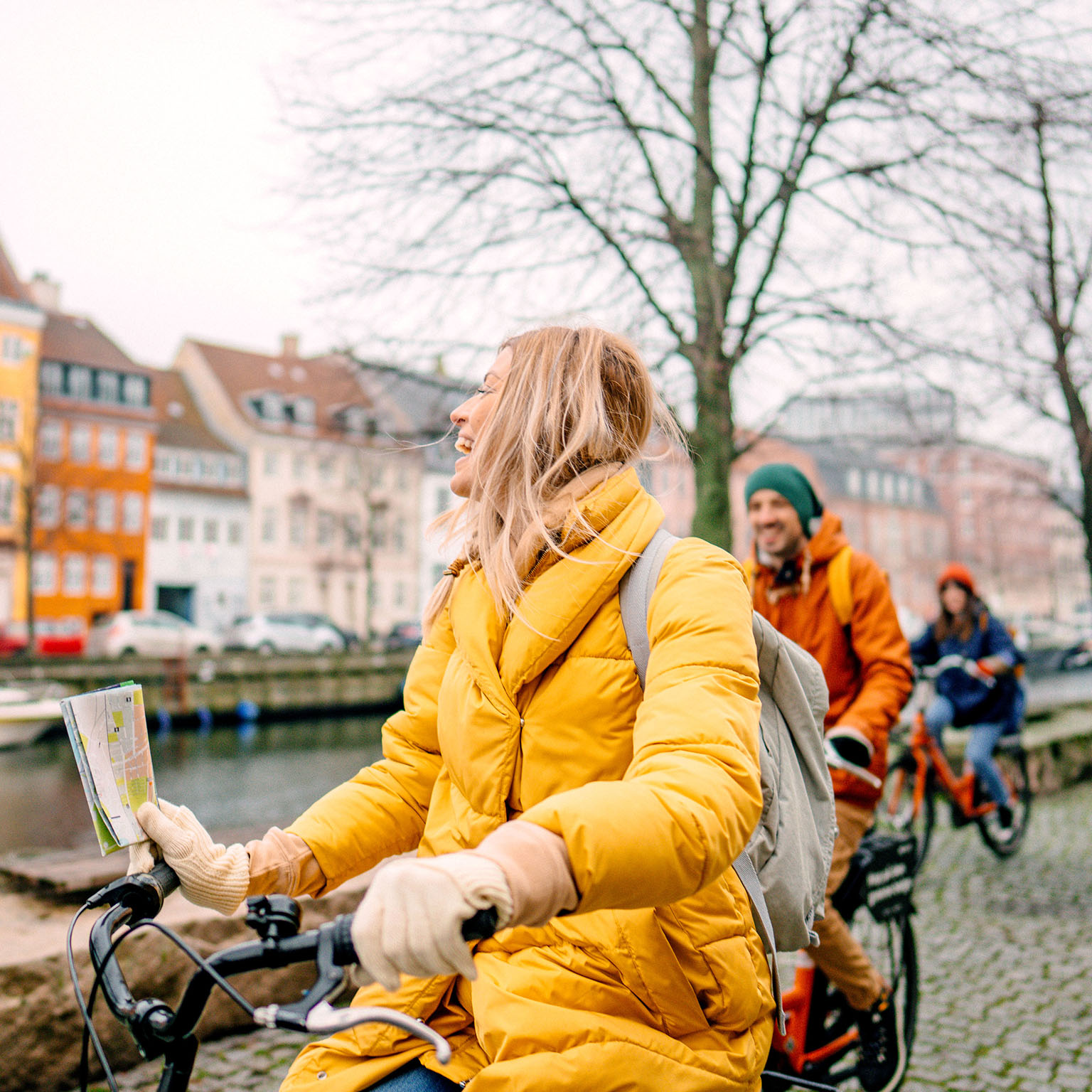 A female travel guide and her group bicycling through the town