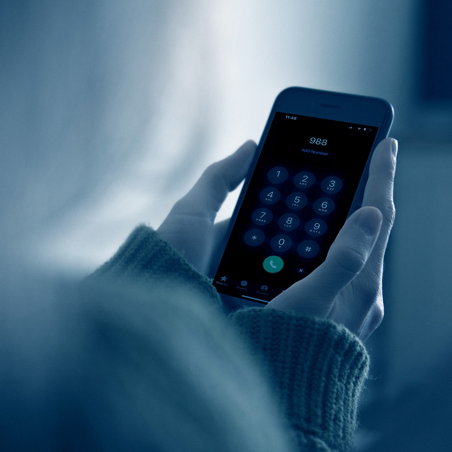Woman looking at blank smart phone screen in the dark at night - stock photo