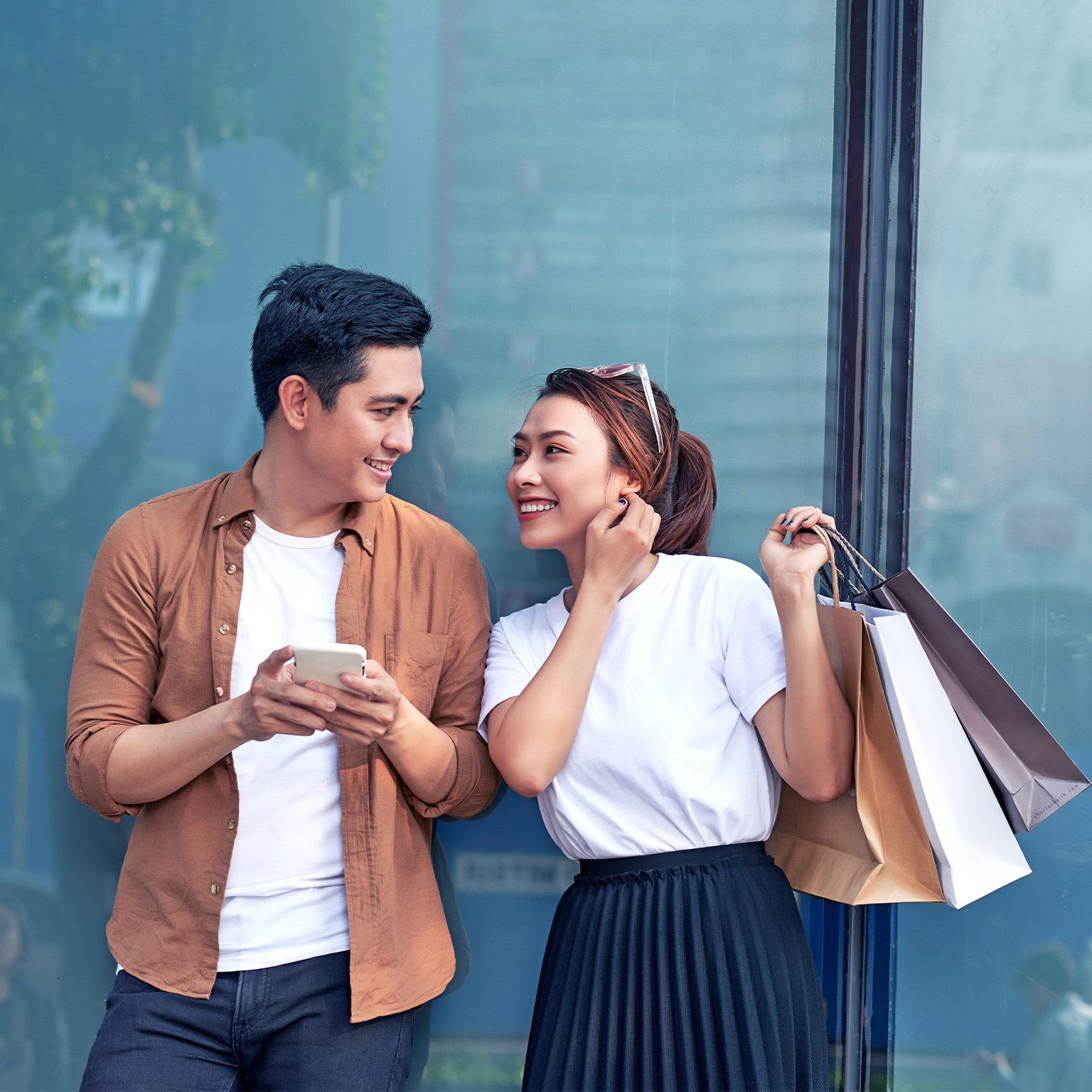 A picture of a couple shopping with smartphone in the city