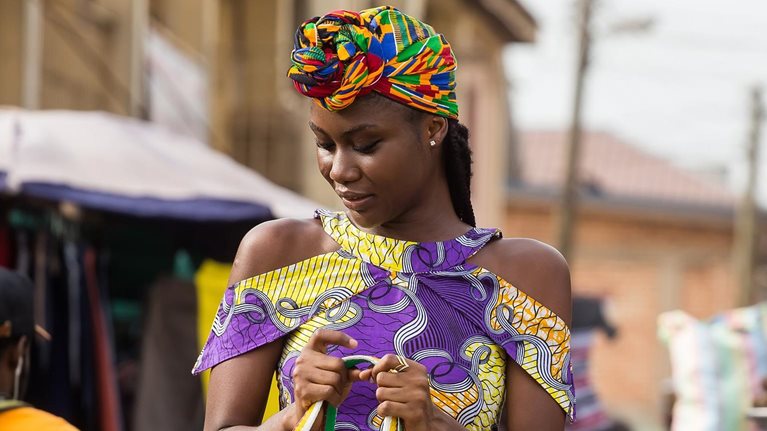 Young woman walking in the market in Accra, Ghana