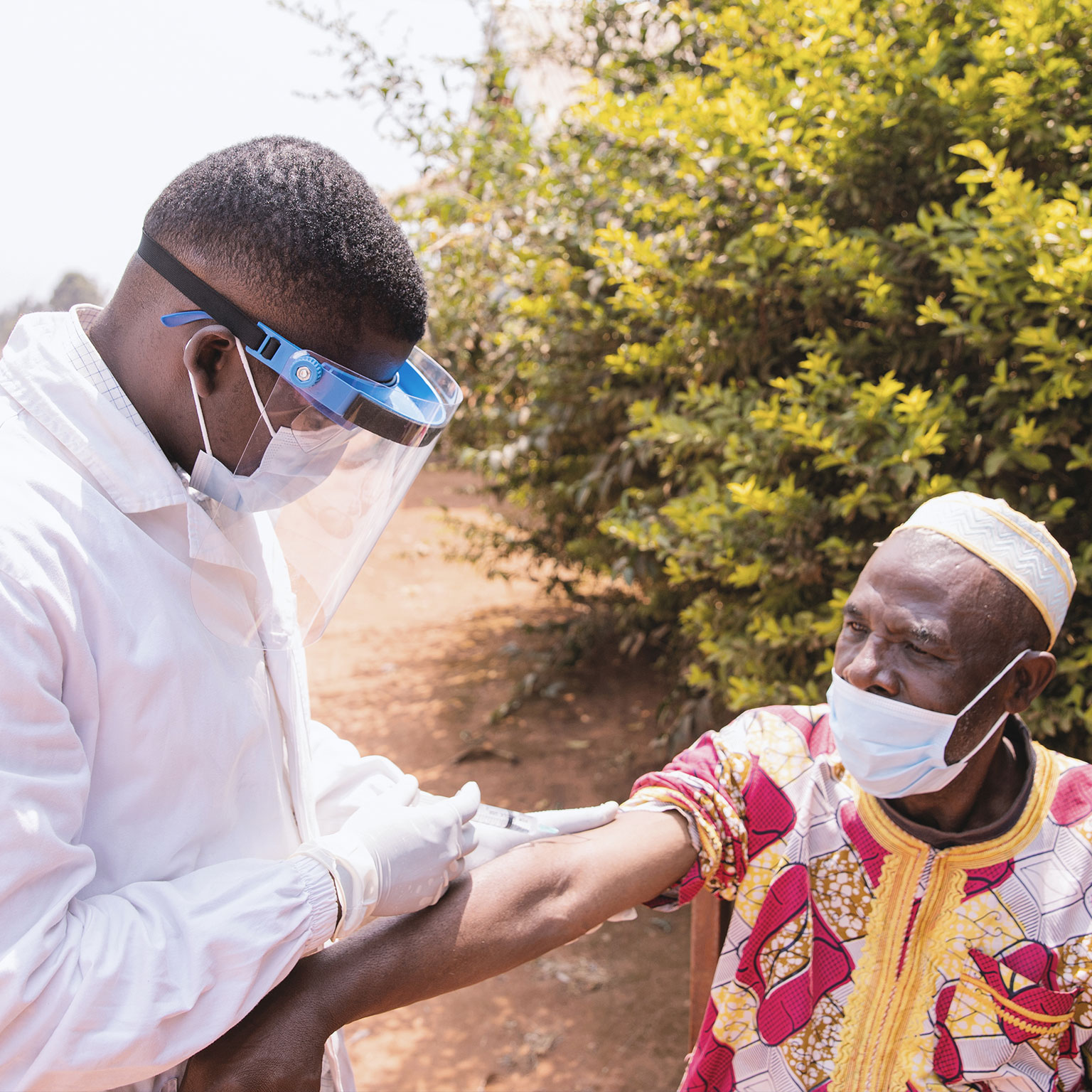 Senior African man getting vaccinated outdoor during Covid-19 pandemic era photo