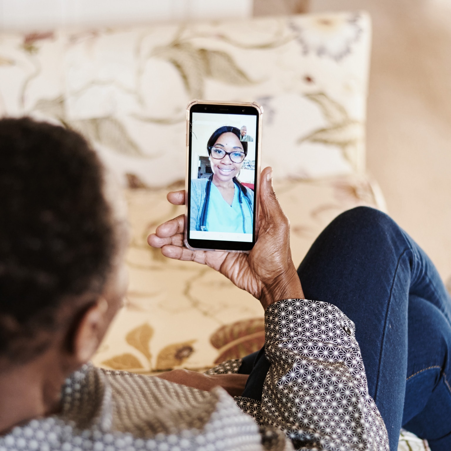 Person sitting on couch while video calling a girl on their smartphone