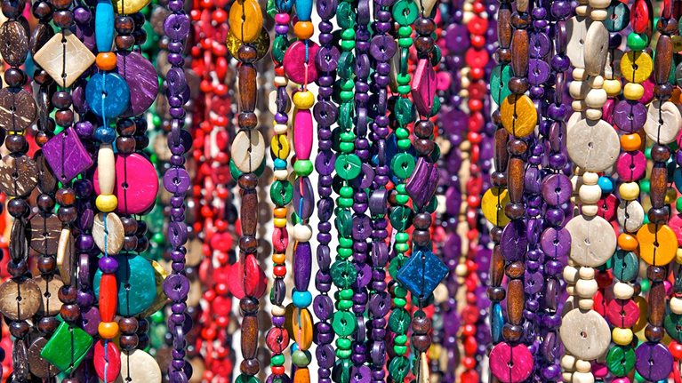 Strings of beaded necklaces for sale.