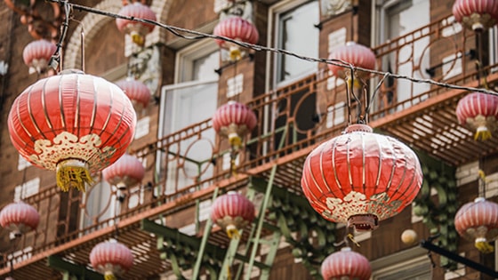 Red colored chinese lanterns strung across a street