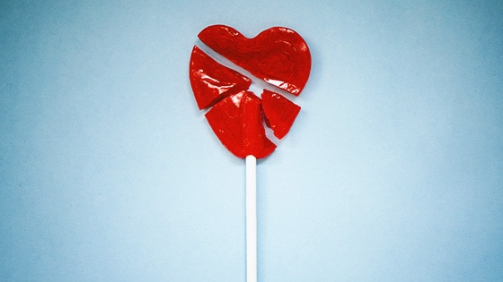 Illustration of a broken heart shaped lolipop