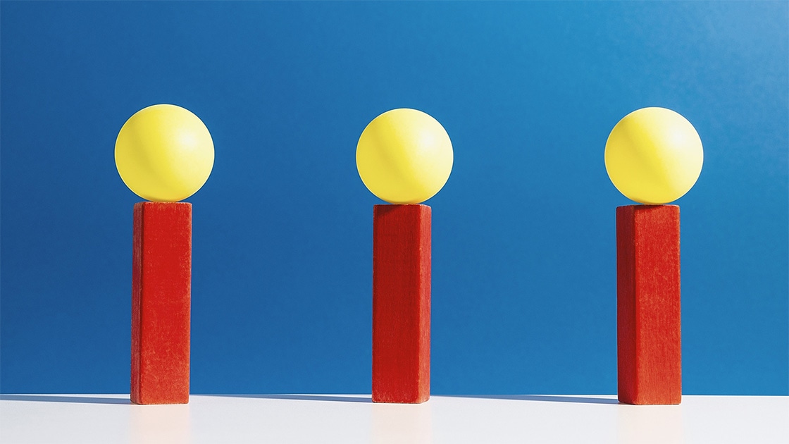 Illustration of three yellow balls on red pillars