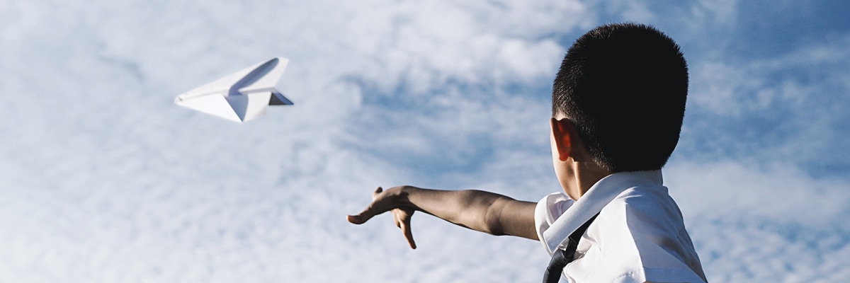 image of child throwing an airplane