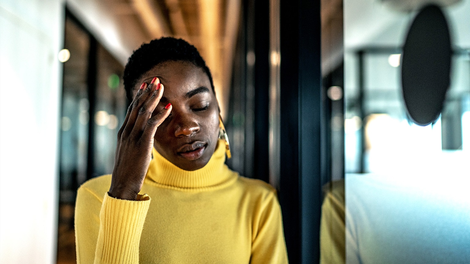 Image of a young Black women looking stressed