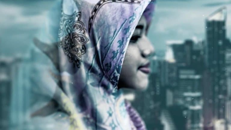 Image of a young woman wearing a hijab with a skyline view behind her
