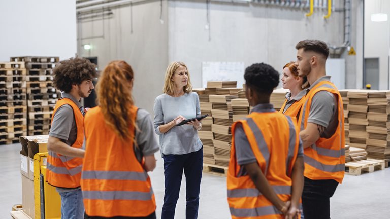 Warehouse manager talking with a team of workers