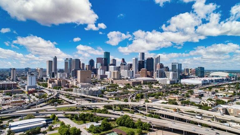 Image of massive freeways with Houston skyline in background