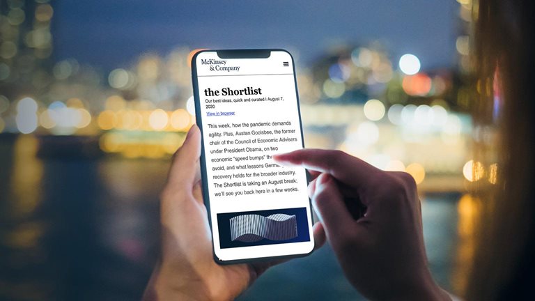 Image of a person holding a cellphone that is open to The Shortlist newsletter