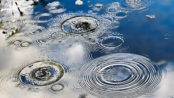 Image of ripples in a water puddle