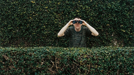 Image of a person using binoculars