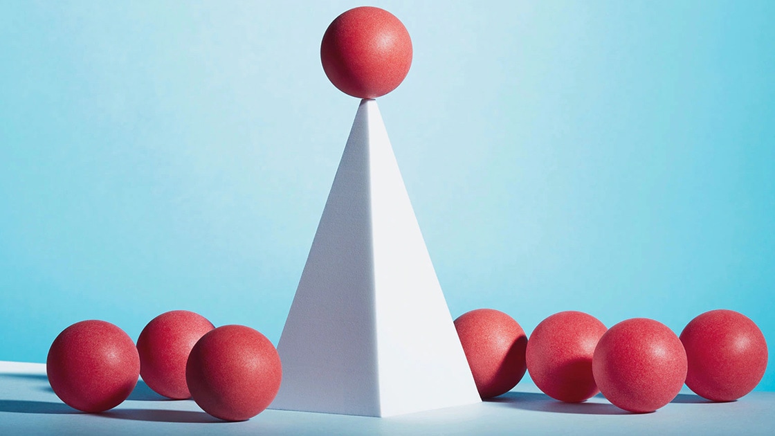 Illustration of a single pyramid with a red ball on top and surrounded by red balls