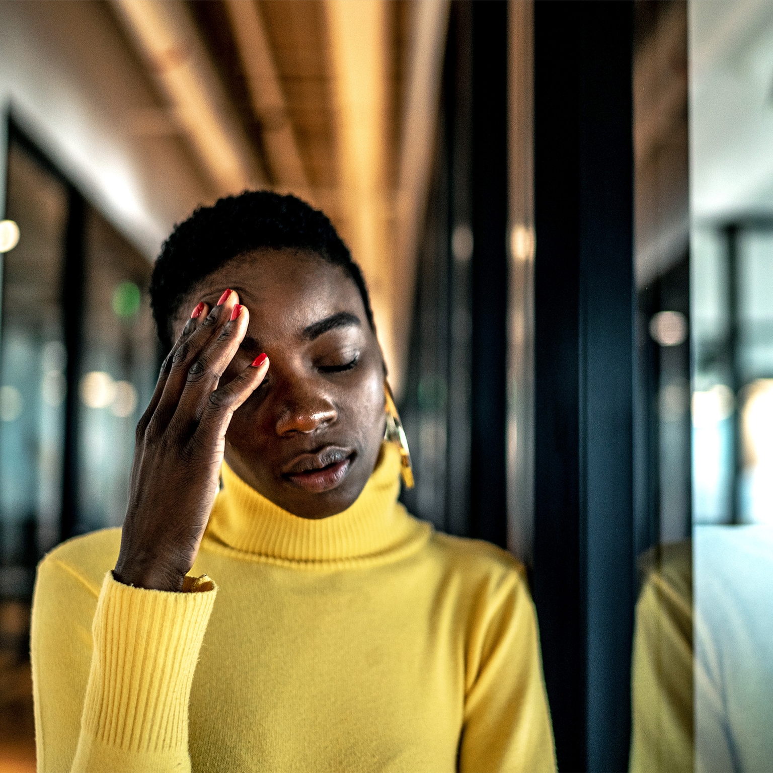 Image of a young Black woman looking stressed