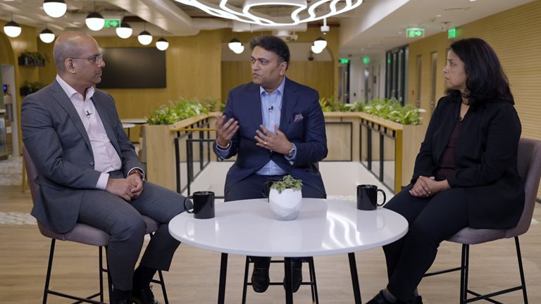 Image of McKinsey colleagues Rajat Dhawan, Alok Kshirsagar, and Anu Madgavkar sitting at a table