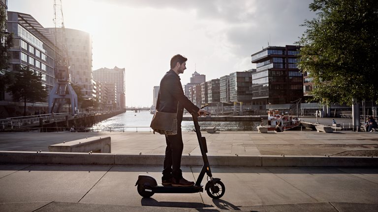 Image of a young man on e-scooter in the city