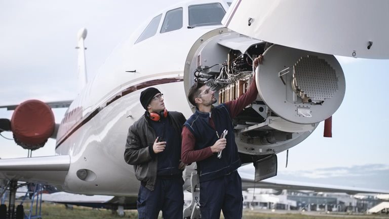 Two men inspecting an aircraft