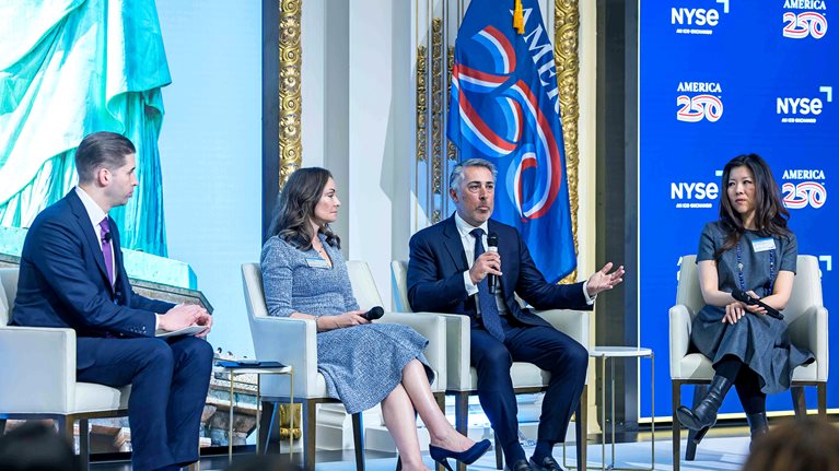 Erick Kutcher, senior partner and chair of North America, pictured speaking into the microphone, on a panel with, from left: Will Goodwin, head of strategic operations and corporate affairs, NYSE, Rosie Rios, chair, America250, and Jayee Koffey, chief global affairs officer, BNY.