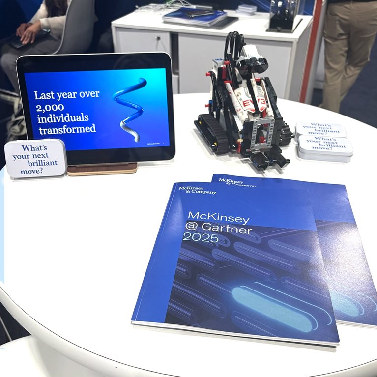 McKinsey brochures and tablet on a table promoting McKinsey at Gartner 2025