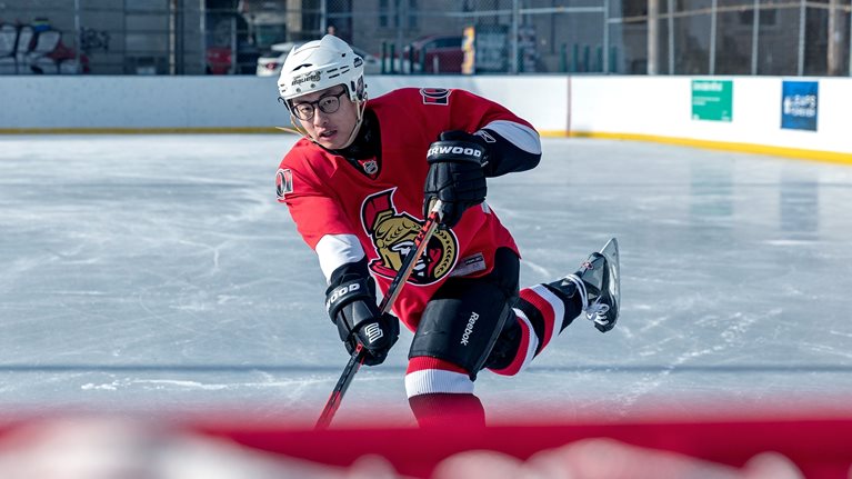 Stephen Xu playing hockey