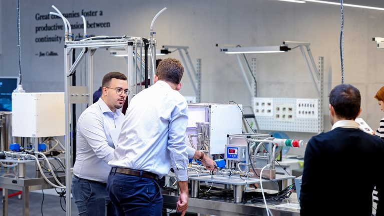 Colleagues collaborate on a production line training