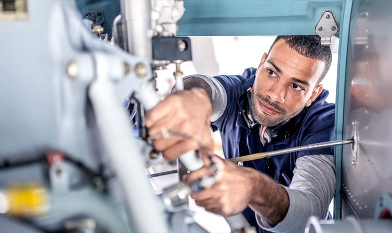 Technician works inside machinery