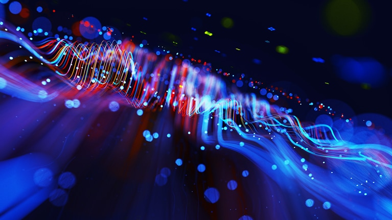 Digital generated image of abstract flowing data made out of glowing blue and red splines moving away from camera on black background.