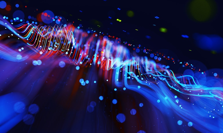 Digital generated image of abstract flowing data made out of glowing blue and red splines moving away from camera on black background.