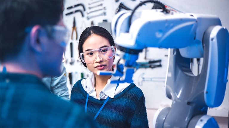 A researcher examines robotics equipment