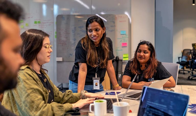 Stephanie Kaiser, senior designer; Rashida Kanchwala, senior software engineer; and Ankita Katiyar, software engineer, all from QuantumBlack, collaborated with Iguazio team members at a recent GenAI hackathon.