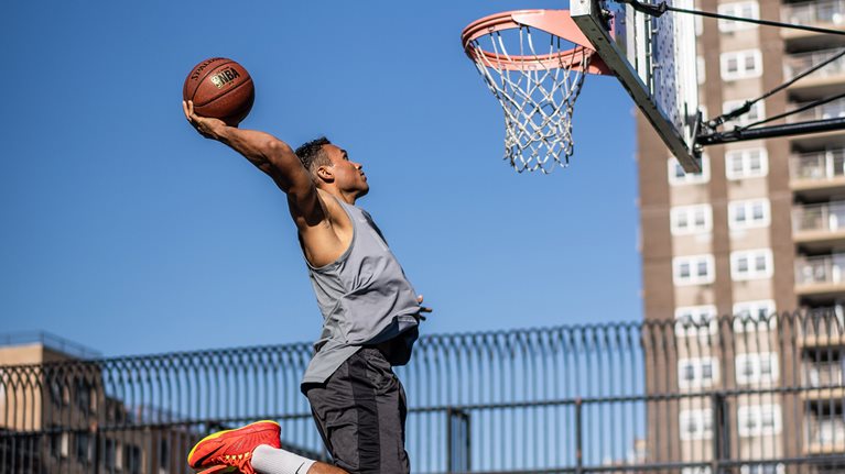 Simon dunking a basketball into a hoop