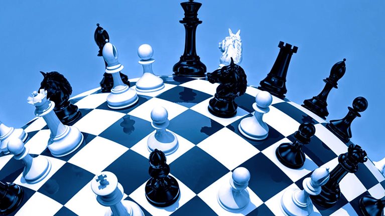 A globe styled as a chessboard, with chess pieces scattered across its surface.